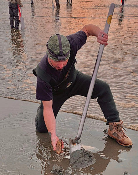 razor clamming on beach at sunset with a Murff's Claminator stainless steel shovel